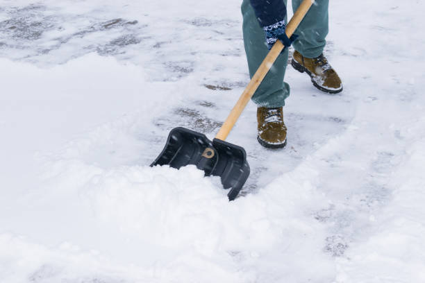 istock an unrecognizable man cleans snow with a shovel in a snowfall. close-up 1912447383