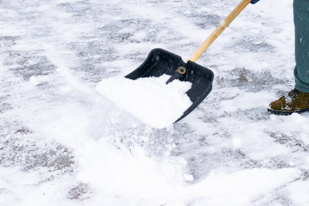 istock an unrecognizable man cleans snow with a shovel in a snowfall. close-up 1912447398