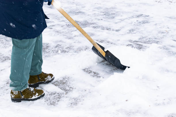 istock an unrecognizable man cleans snow with a shovel in a snowfall 1912447399