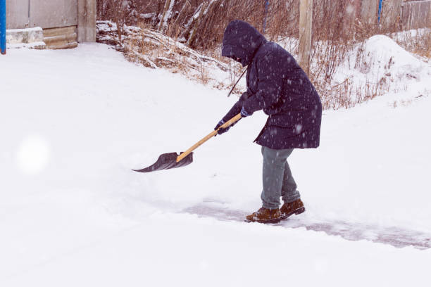 istock an unrecognizable man cleans snow with a shovel in a snowfall 1912447913