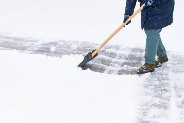 istock an unrecognizable man cleans snow with a shovel in a snowfall 1912447923