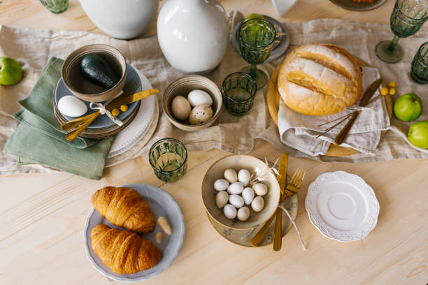 istock Festive Easter table with eggs, pastries and fruit. Top view of the decorated dining table 1912448958