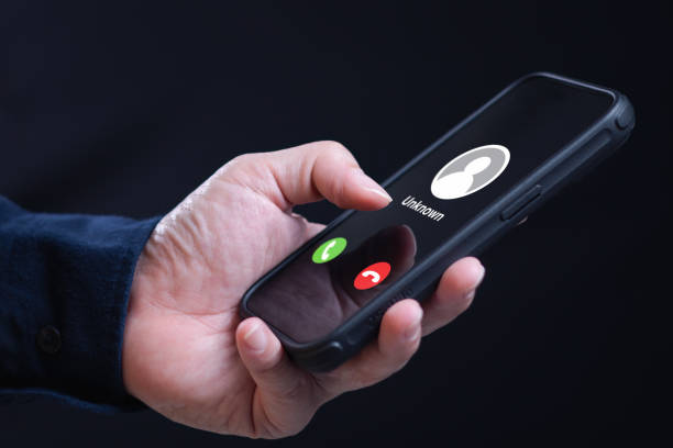 istock Incoming phone call from unknown number scammer caller 1912473107