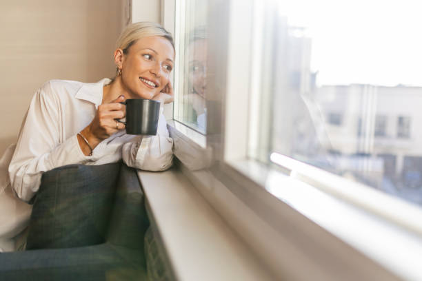 istock A young woman enjoying coffee time by the window 1912474647