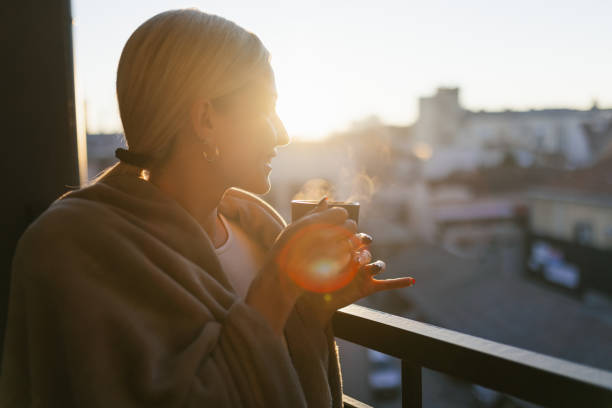 istock A young woman drinking coffee on balcony 1912490167