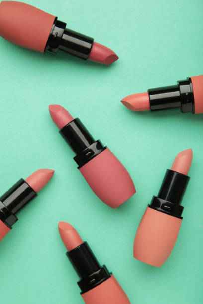 istock Different pastel lipsticks on mint background. Vertical photo 1912504702