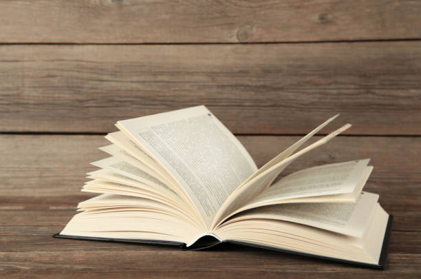 istock Open book on grey wooden background. Space for text 1912508374