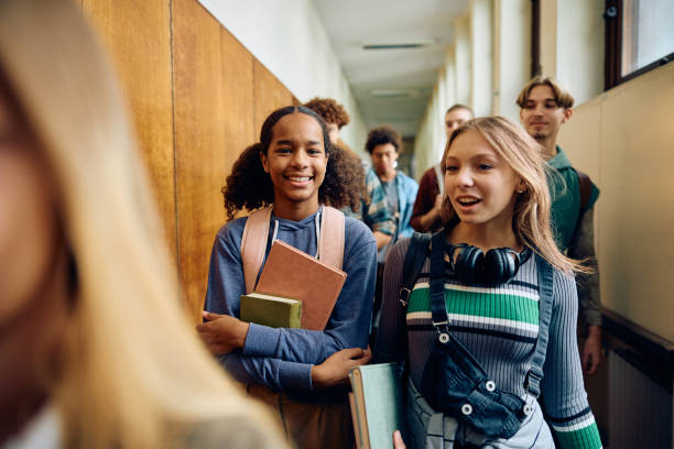 istock Black student and her friend walking through high school hallway. 1912512568