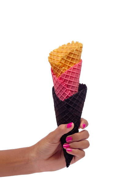 istock Woman's hand holding empty wafer three cone for ice cream. Close up, High resolution product 1912560377