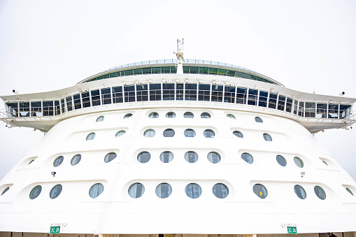 Galvaston, United States – December 21, 2023: The exterior view of a tall luxury cruise ship tower illuminated by the sun