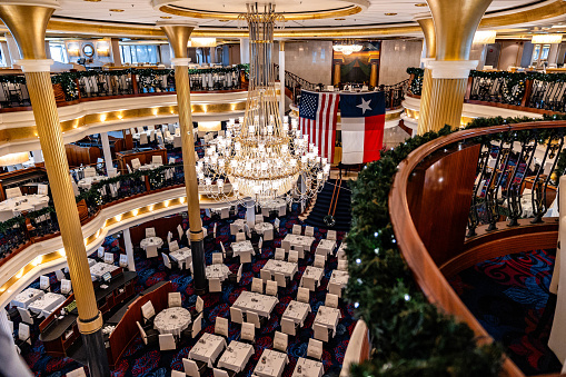 Cozumel, Mexico – December 25, 2023: A modern, bright atrium in a ship interior, with tables and chairs arranged neatly