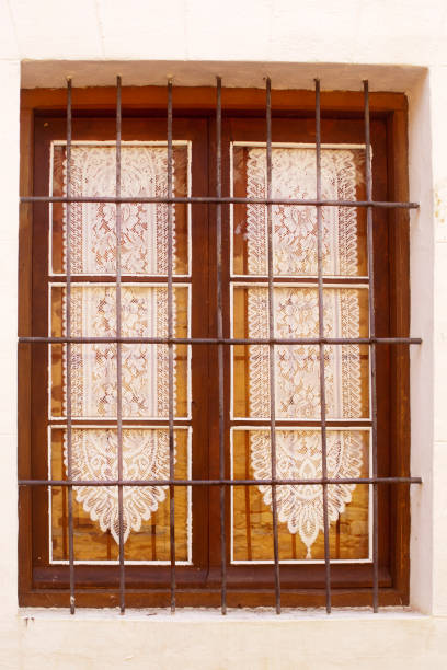 Old stone house, closed window, embroidery curtain. Old town Castrillo de los Polvazares, León, Castilla y León, Spain.