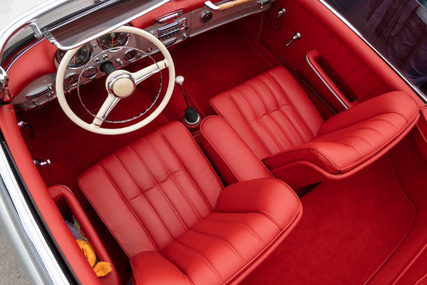 istock Interior of a classic vintage car, red leather. 1912569073