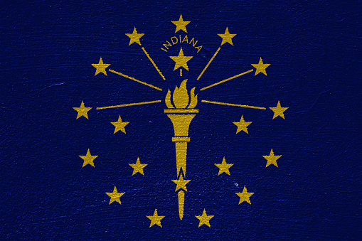 Flag of Indiana USA state on a textured background. Concept collage.