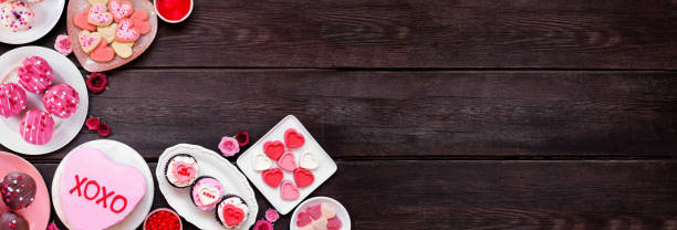 istock Valentines Day corner border with assorted fun desserts and sweets on a dark wood banner background 1912617499