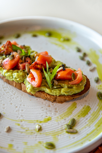 Tasty appetizing sandwich bread with mashed avocado served on plate.