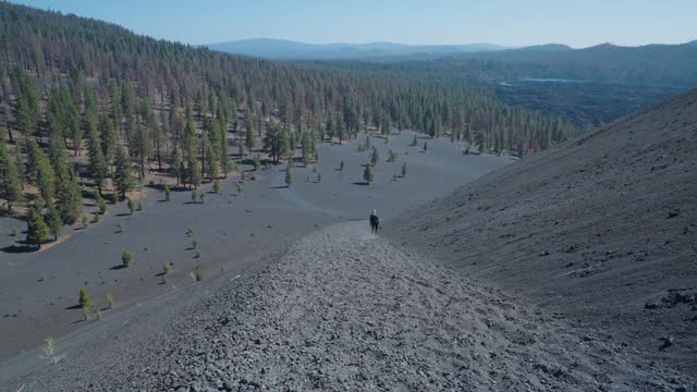 Woman hiking down ramp of Cinder Cone Trail in Lassen National Park