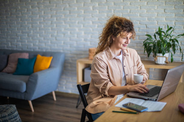 istock Young female entrepreneur working on a laptop and drinking coffee 1912862886