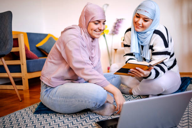 istock Muslim college students studying together at home 1912904433