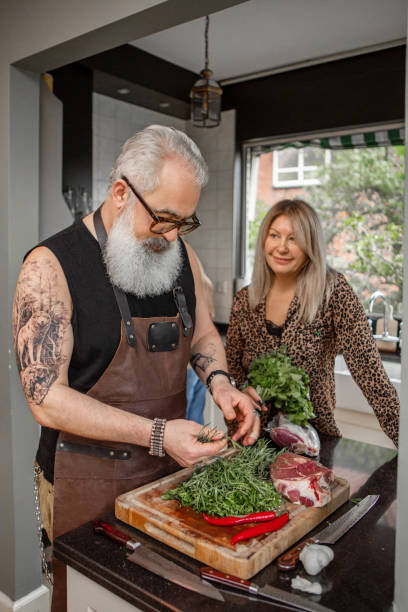 istock Handsome bearded husband cooking at home with the family 1912939366