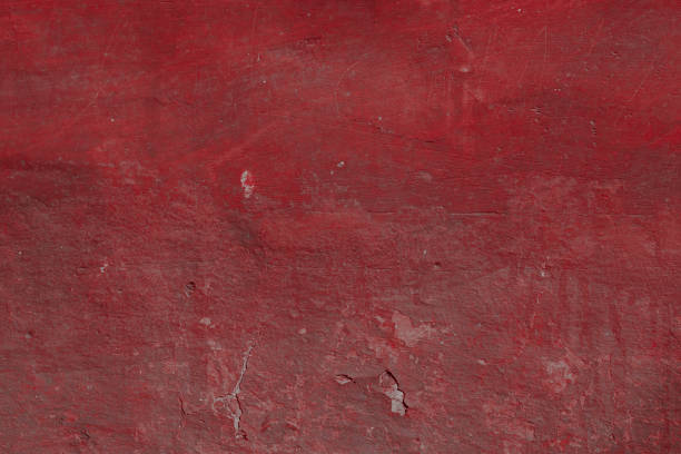 istock Scary red concrete wall with deep scratches and chips. Various variations of abrasions. 1912945625