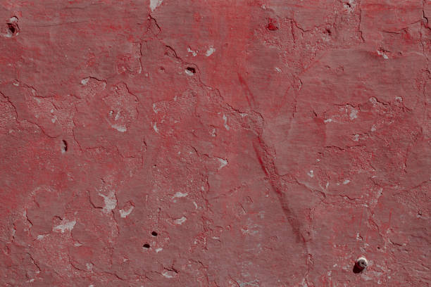istock Scary red concrete wall with deep scratches and chips. Various variations of abrasions. 1912947727