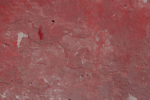 istock Scary red concrete wall with deep scratches and chips. Various variations of abrasions. 1912948786