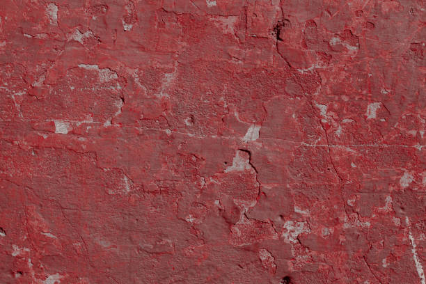 istock Scary red concrete wall with deep scratches and chips. Various variations of abrasions. 1912948795