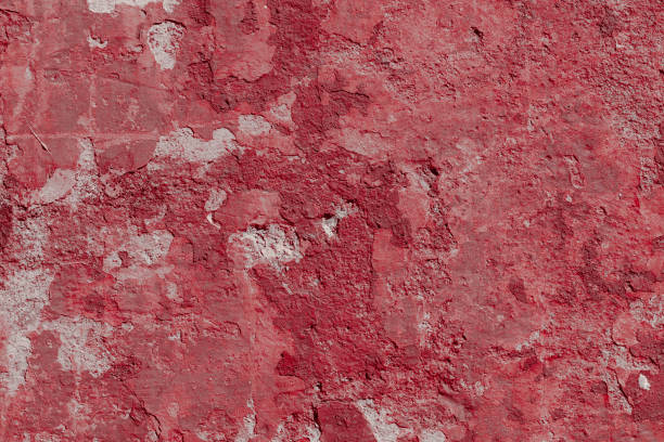 istock Scary red concrete wall with deep scratches and chips. Various variations of abrasions. 1912957214