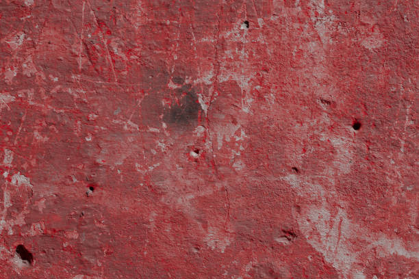 istock Scary red concrete wall with deep scratches and chips. Various variations of abrasions. 1912958767