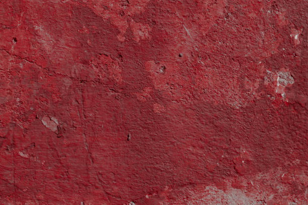 istock Scary red concrete wall with deep scratches and chips. Various variations of abrasions. 1912958768