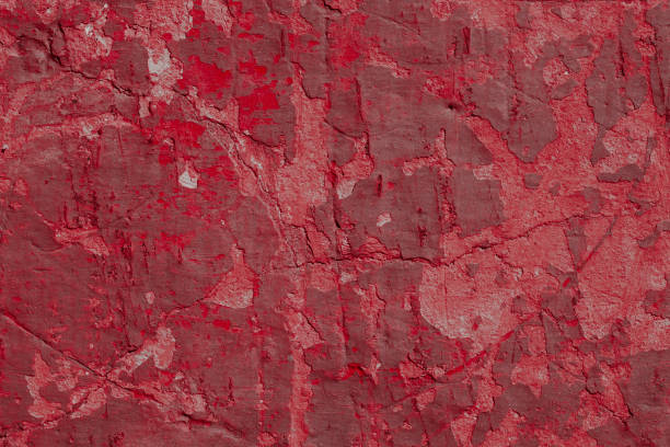 istock Scary red concrete wall with deep scratches and chips. Various variations of abrasions. 1912960382