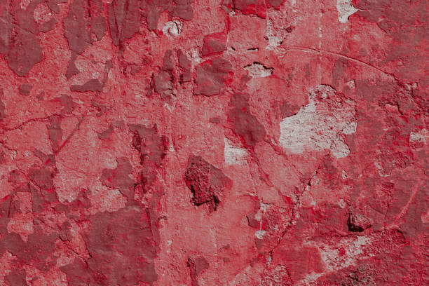 Scary red concrete wall with deep scratches and chips. Various variations of abrasions.