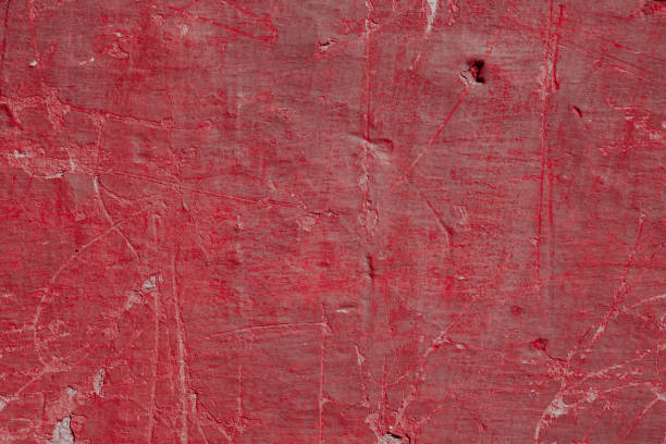 istock Scary red concrete wall with deep scratches and chips. Various variations of abrasions. 1912975958