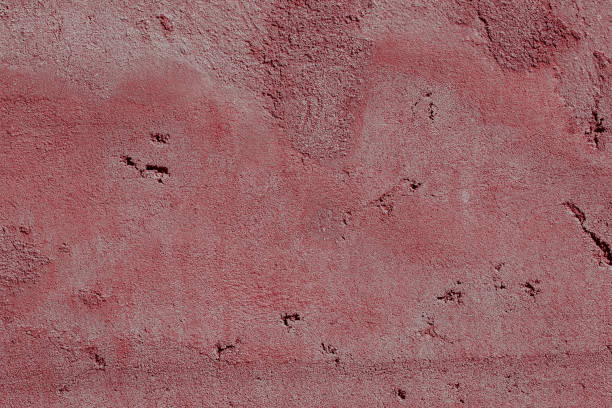 istock Scary red concrete wall with deep scratches and chips. Various variations of abrasions. 1912983371