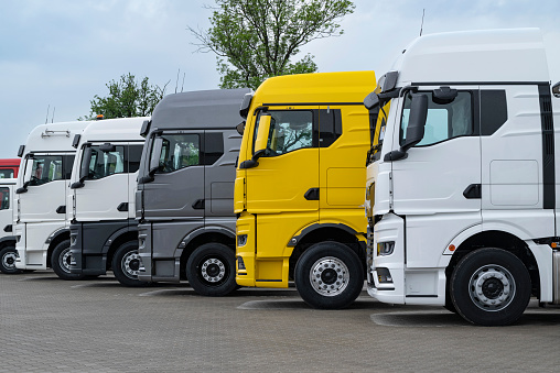 Niepolomice, Poland - 16th May, 2023: Trucks on a public parking in a row. Free parking spaces for trucks are an increasing problem on European roads.