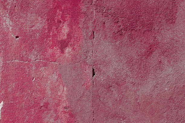 istock Scary red concrete wall with deep scratches and chips. Various variations of abrasions. 1912992834