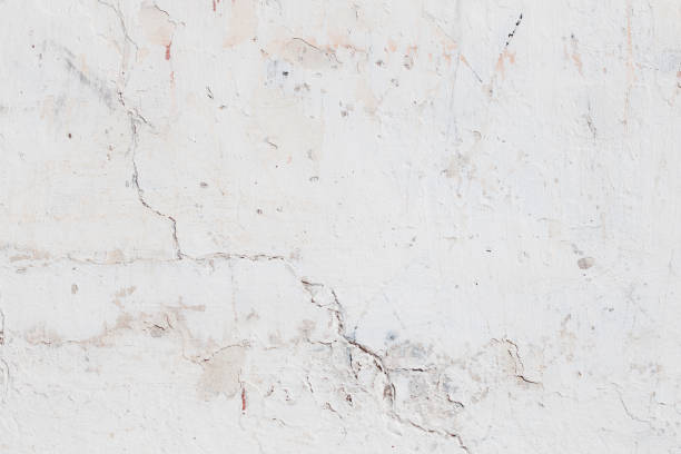 istock White red concrete wall with deep scratches and chips. Various variations of abrasions. 1913016064