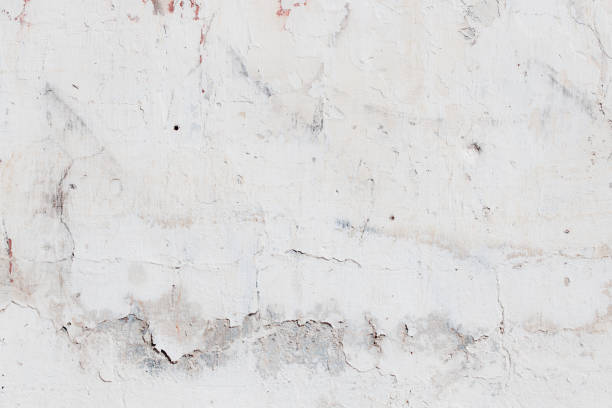 istock White red concrete wall with deep scratches and chips. Various variations of abrasions. 1913016067
