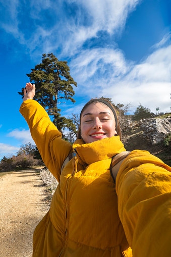 Young caucasian hiker taking selfie portrait in sierra de las nieves natural park, spain. Tourism, sport, lifestyle.