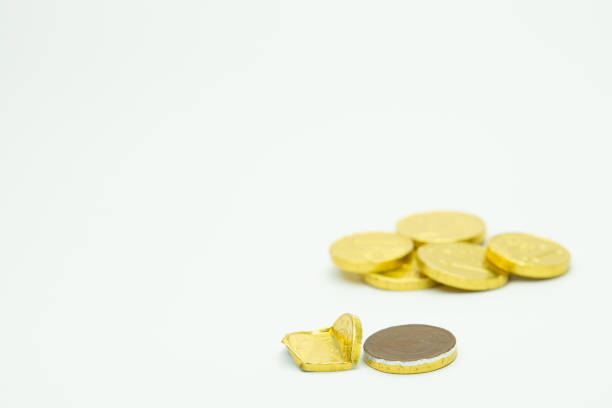Stack of chocolate coins isolated on white background copy space group of golden chocolate coins money