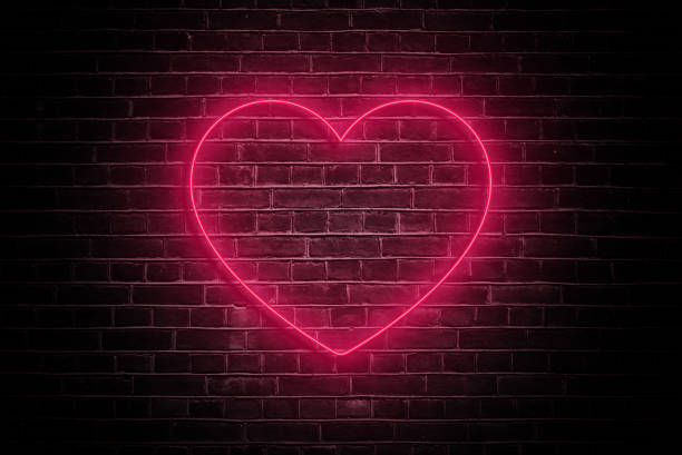 istock Neon Love: Valentine's Day Heart on Dark Brick Wall 1913084916