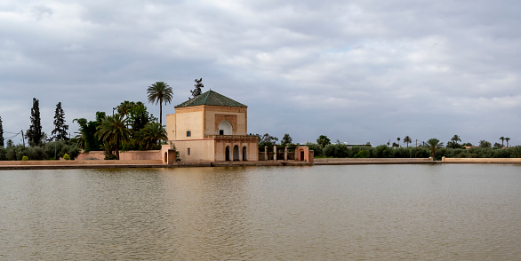 Marrakesh, Morocco - may 18, 2023: view of the building in front of the Bassin Menara, once an important water reserve for Marrakesh.