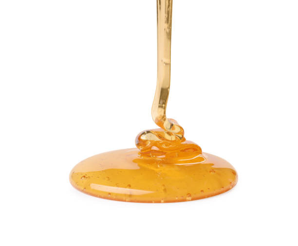 istock Pouring tasty natural honey isolated on white 1913124213