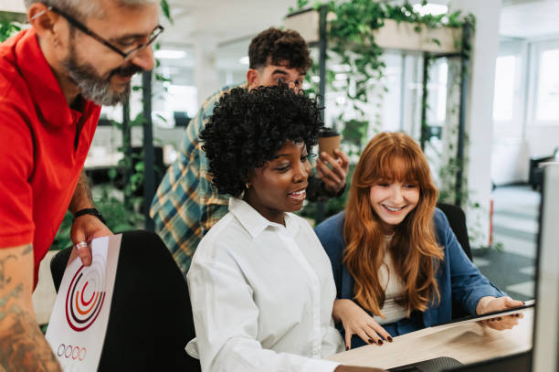 istock An interracial businesswoman is collaborating on project with team. 1913125748