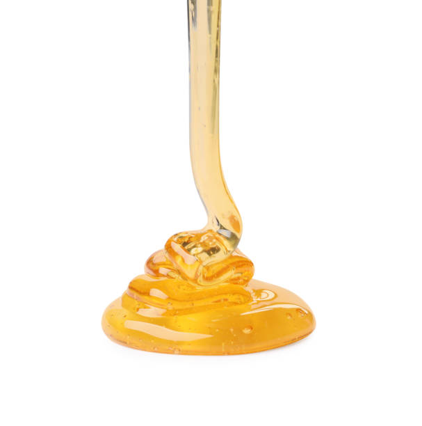 istock Pouring tasty natural honey isolated on white 1913129868
