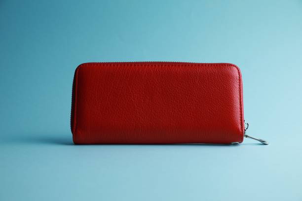 istock One stylish leather purse on light blue background 1913166462