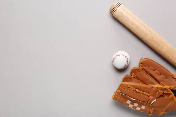 istock Baseball glove, bat and ball on light grey background, flat lay. Space for text 1913185962