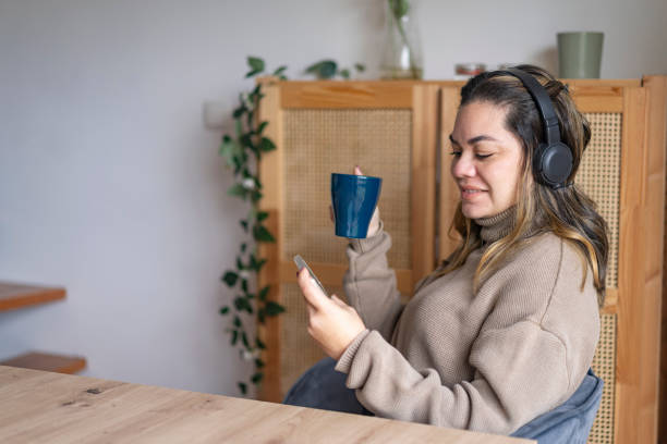 istock Woman making video call on smartphone at home 1913200466