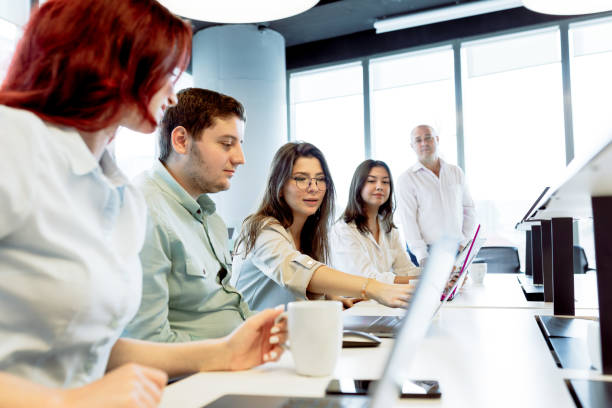 istock Dynamic Business Collaboration: Multiracial Business Team Engaged in a Productive Staff Meeting. Diverse Group  Planning Strategically, Brainstorming, Collaborating, and Working a Modern Office Setting 1913226901